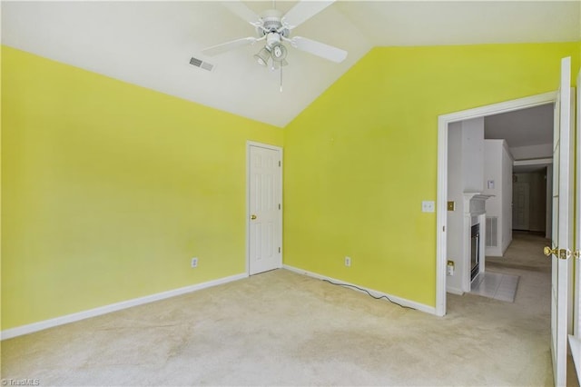 9 Whitdale Pt, Greensboro, NC 27455 - carpeted empty room featuring lofted ceiling, a ceiling fan, and a fireplace with flush hearth