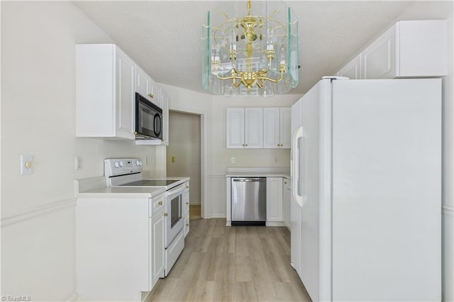 9 Whitdale Pt, Greensboro, NC 27455 - kitchen with white appliances, white cabinetry, light wood-type flooring, a chandelier, and light countertops
