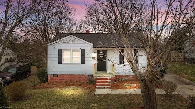 bungalow-style home featuring a shingled roof, a chimney, and crawl space