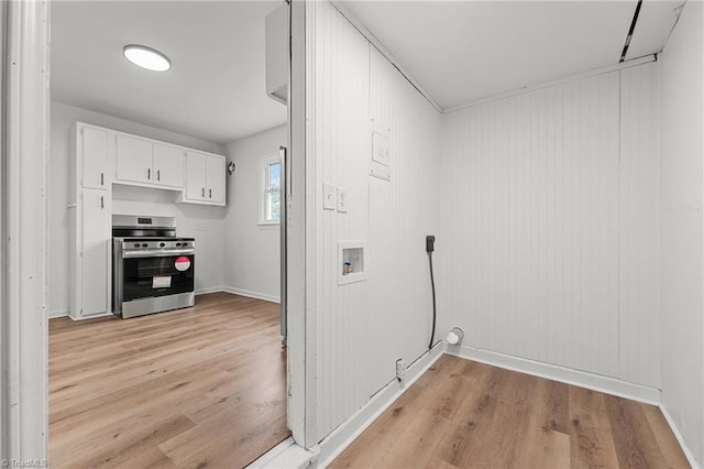 laundry room with laundry area, hookup for a washing machine, light wood-style floors, and baseboards