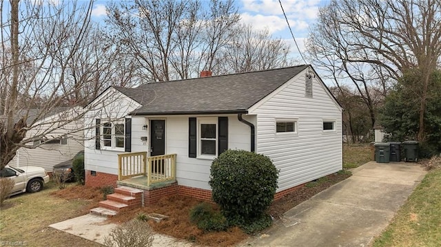 bungalow-style home featuring crawl space, roof with shingles, and a chimney