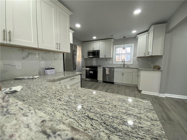 kitchen with white cabinetry, appliances with stainless steel finishes, and sink