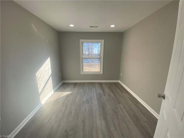 spare room with hardwood / wood-style floors