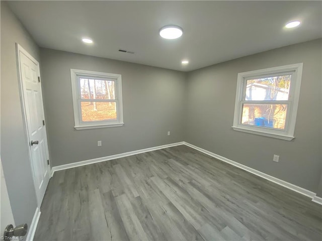 unfurnished room featuring hardwood / wood-style floors and a wealth of natural light