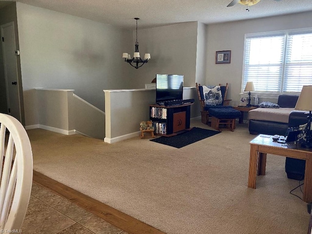 7533 Greenmeadow Dr, Tobaccoville, NC 27050 - carpeted living area with a chandelier, baseboards, a textured ceiling, and a ceiling fan