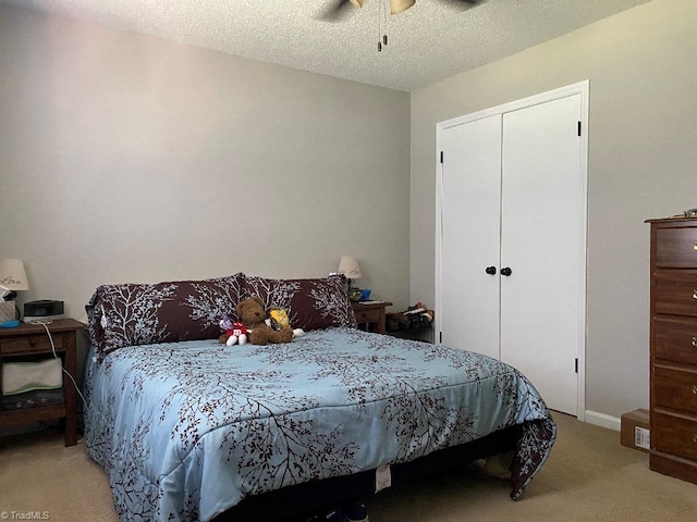 7533 Greenmeadow Dr, Tobaccoville, NC 27050 - bedroom featuring light carpet, a closet, a textured ceiling, and ceiling fan