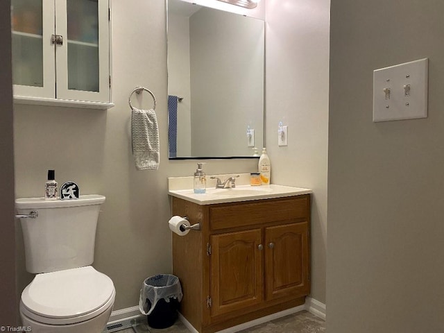 7533 Greenmeadow Dr, Tobaccoville, NC 27050 - bathroom with toilet, vanity, and baseboards