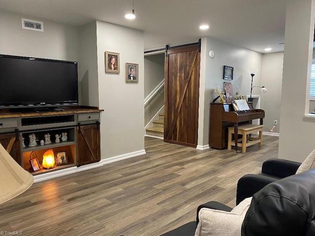 7533 Greenmeadow Dr, Tobaccoville, NC 27050 - living room with a barn door, wood finished floors, baseboards, recessed lighting, and stairs
