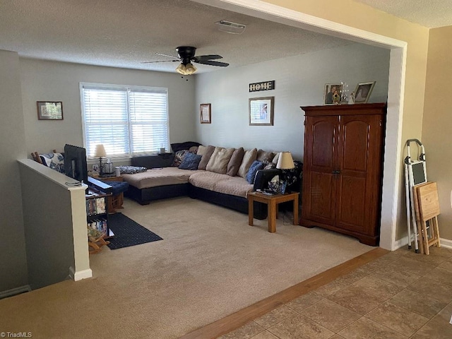 7533 Greenmeadow Dr, Tobaccoville, NC 27050 - living room with a textured ceiling, ceiling fan, light colored carpet, light tile patterned floors, and baseboards