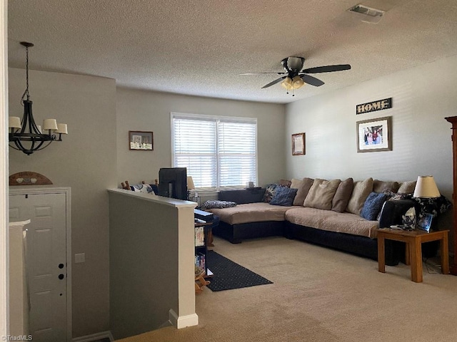 7533 Greenmeadow Dr, Tobaccoville, NC 27050 - carpeted living room with a chandelier, a textured ceiling, and a ceiling fan