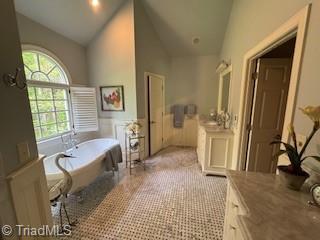 105 Finborough Ct, Kernersville, NC 27284 - bathroom featuring a soaking tub, plenty of natural light, vanity, and wainscoting