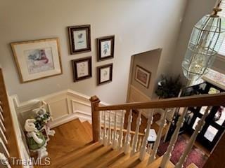 105 Finborough Ct, Kernersville, NC 27284 - stairway with wood finished floors, a decorative wall, and a wainscoted wall