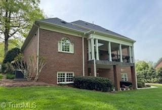 105 Finborough Ct, Kernersville, NC 27284 - back of property with a lawn, brick siding, and a sunroom