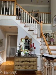 105 Finborough Ct, Kernersville, NC 27284 - stairs featuring wainscoting, wood finished floors, ornamental molding, and a decorative wall