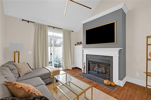 living room featuring vaulted ceiling and hardwood / wood-style flooring