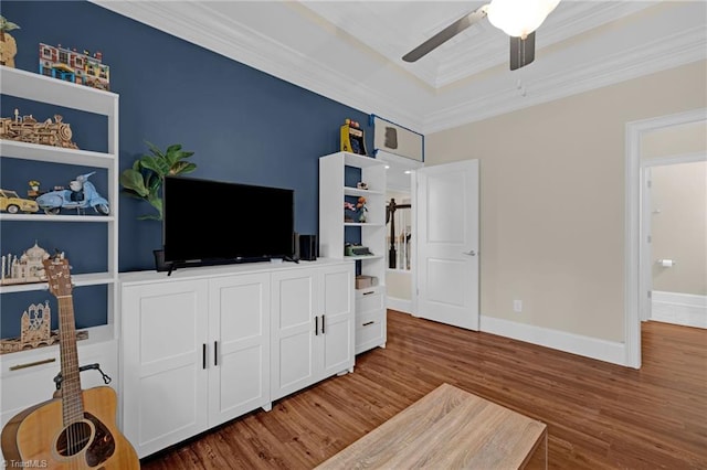 bedroom featuring dark hardwood / wood-style flooring, ceiling fan, and ornamental molding