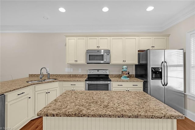 kitchen featuring hardwood / wood-style floors, kitchen peninsula, sink, and appliances with stainless steel finishes