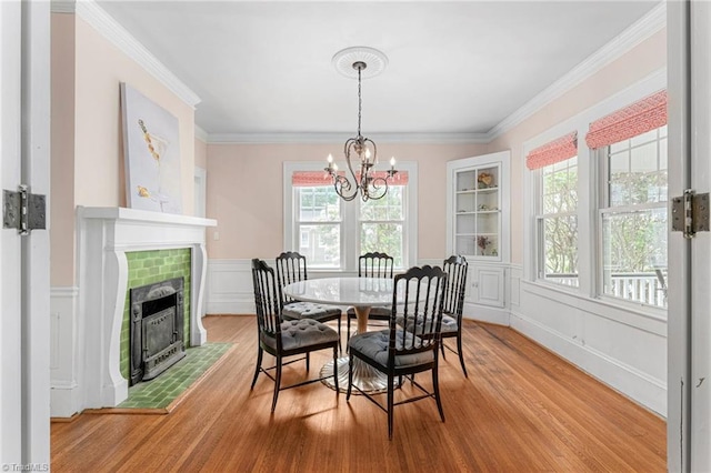 3054 Country Club Rd, Winston-Salem, NC 27104 - dining space with a chandelier, light wood-type flooring, plenty of natural light, crown molding, and a wainscoted wall