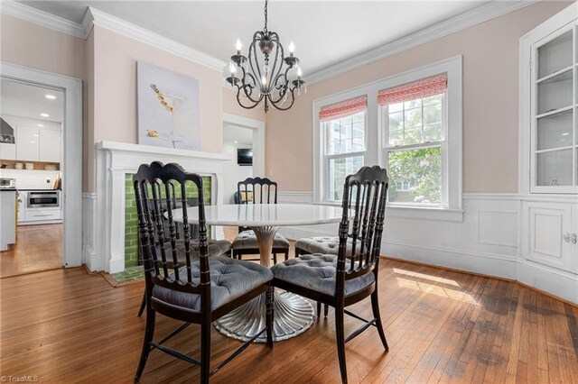 3054 Country Club Rd, Winston-Salem, NC 27104 - dining room with hardwood / wood-style flooring, a chandelier, crown molding, and wainscoting