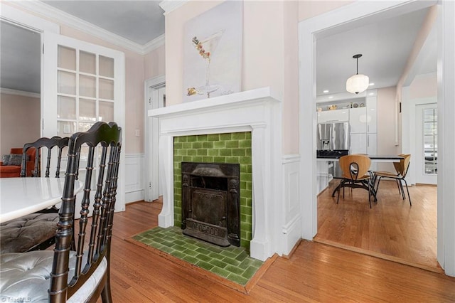 3054 Country Club Rd, Winston-Salem, NC 27104 - living room featuring wood finished floors, ornamental molding, a fireplace with flush hearth, and wainscoting