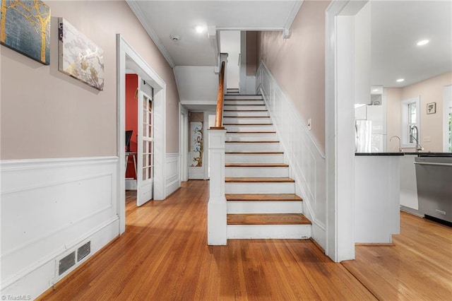 3054 Country Club Rd, Winston-Salem, NC 27104 - stairway with wainscoting, wood finished floors, recessed lighting, and a decorative wall