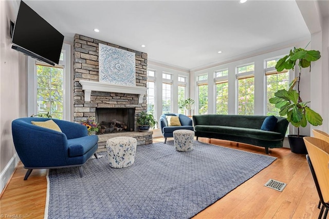 3054 Country Club Rd, Winston-Salem, NC 27104 - living area with wood finished floors, a stone fireplace, crown molding, recessed lighting, and baseboards