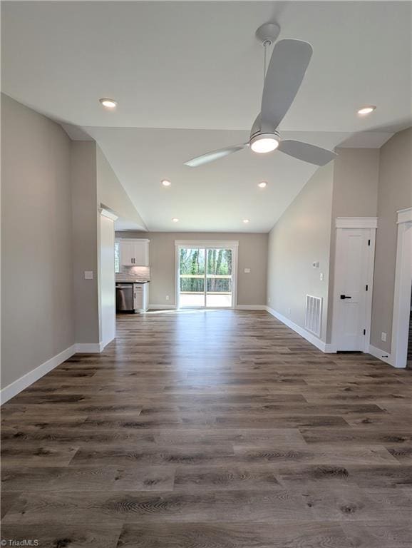 unfurnished living room with dark wood-style floors, baseboards, visible vents, and a ceiling fan