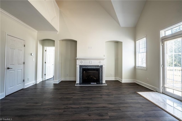 unfurnished living room with dark wood-style floors, a fireplace, and baseboards