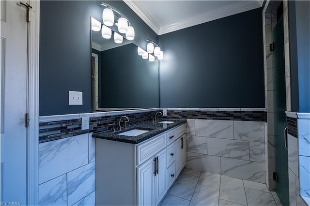 full bath featuring ornamental molding, marble finish floor, a sink, and tile walls