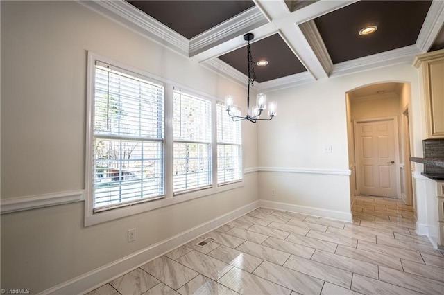 unfurnished dining area with ornamental molding, coffered ceiling, and baseboards