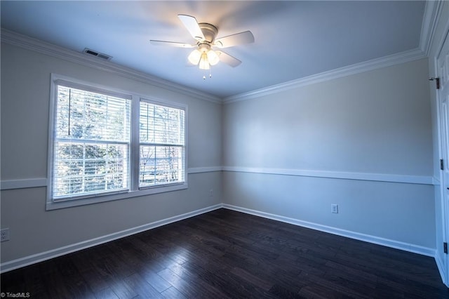 spare room with ornamental molding, visible vents, ceiling fan, and dark wood-style floors