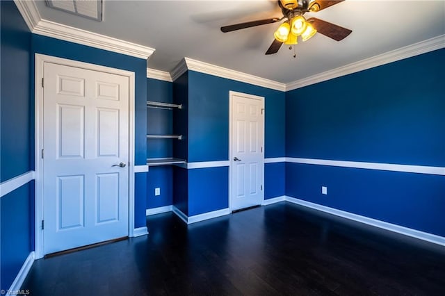 unfurnished bedroom featuring ornamental molding, visible vents, baseboards, and wood finished floors