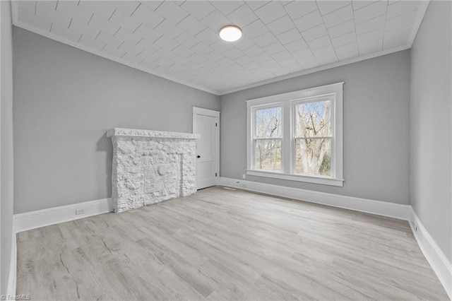 interior space featuring ornamental molding and light hardwood / wood-style floors