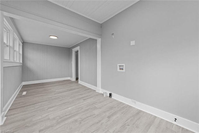 empty room featuring crown molding and light hardwood / wood-style flooring