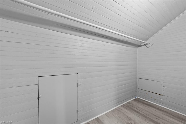 interior space with lofted ceiling and light hardwood / wood-style floors