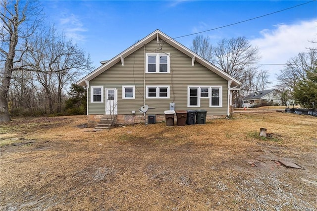 rear view of property with cooling unit