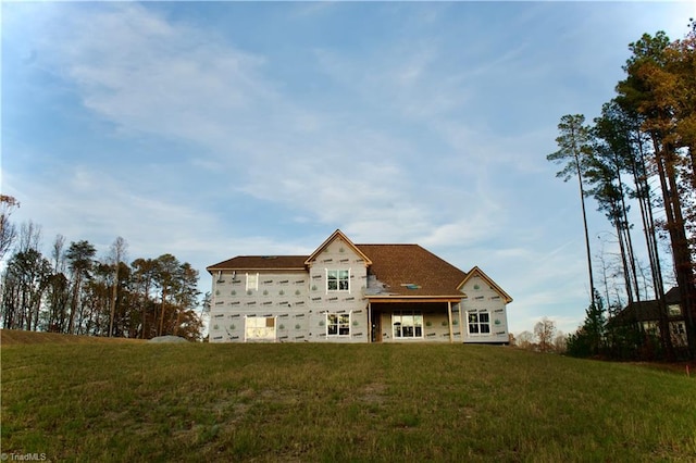 back of property featuring a lawn