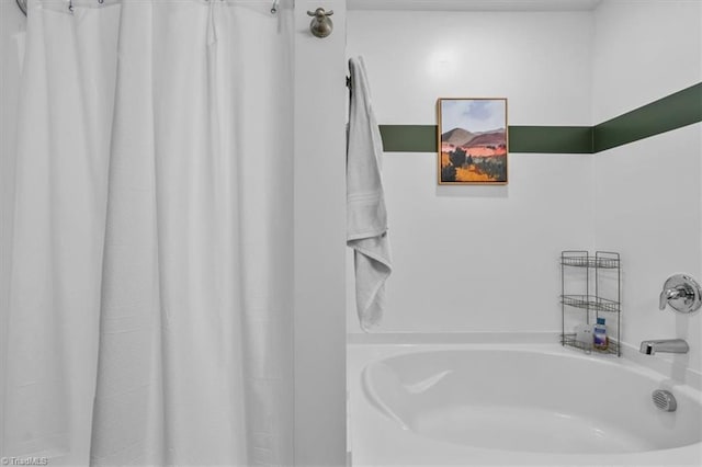 bathroom with a shower with curtain and a bathtub