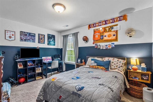 carpeted bedroom featuring visible vents