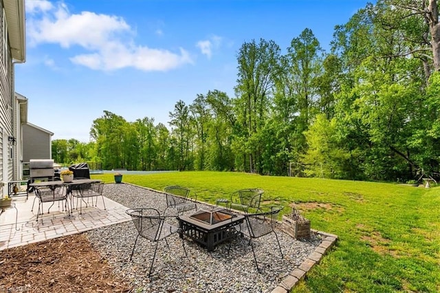 view of yard with a patio and a fire pit