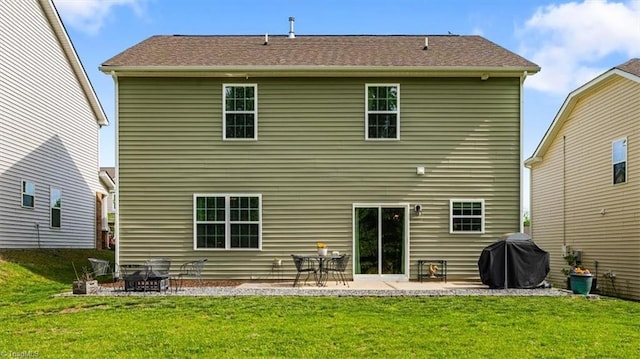 rear view of property featuring a yard and a patio area