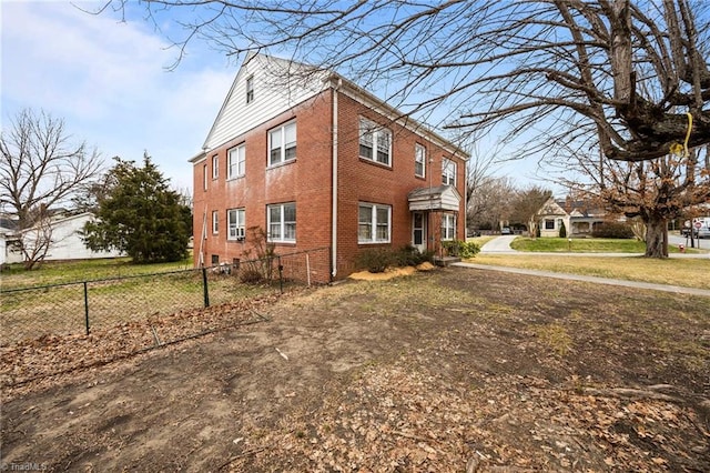 view of home's exterior featuring fence and brick siding