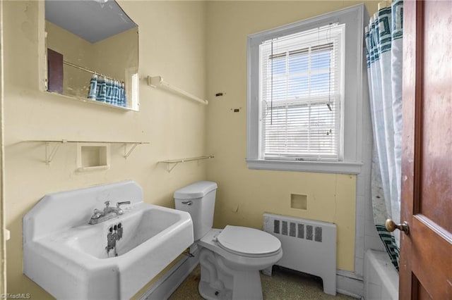 bathroom featuring toilet and radiator heating unit