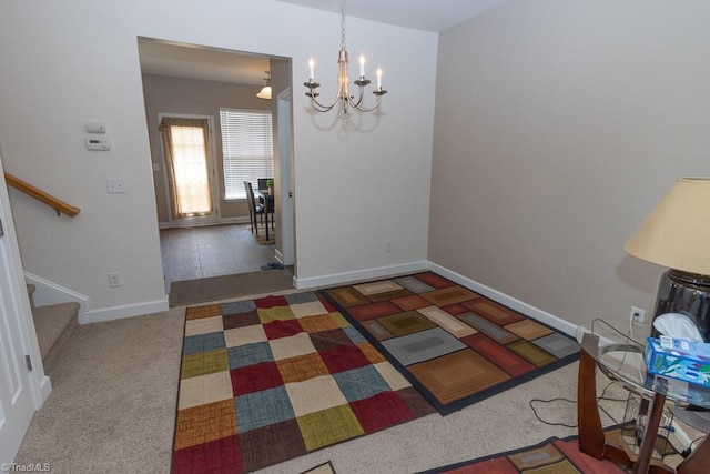 dining area featuring a chandelier, stairs, baseboards, and carpet flooring