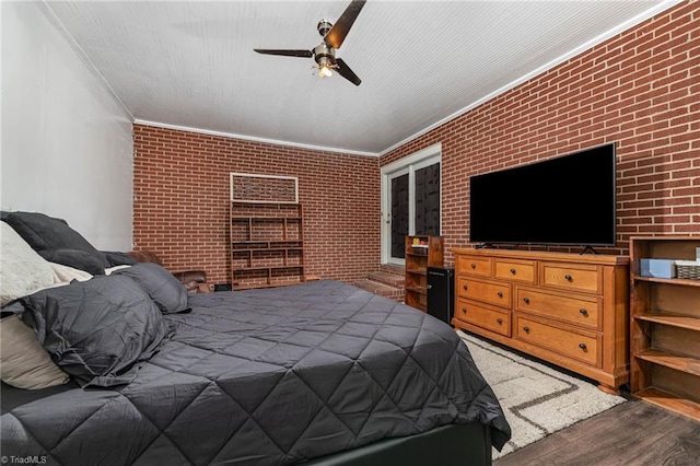 356 Davie Academy Rd, Mocksville, NC 27028 - bedroom with crown molding, wood finished floors, brick wall, and a ceiling fan