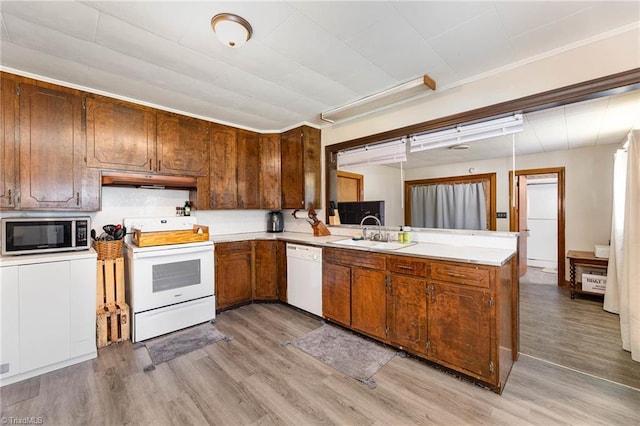 356 Davie Academy Rd, Mocksville, NC 27028 - kitchen with white appliances, light wood finished floors, a peninsula, and a sink