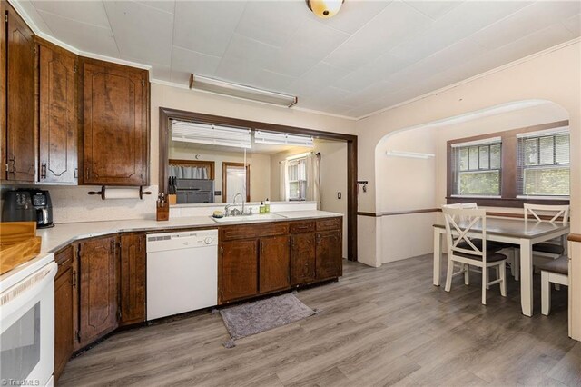 356 Davie Academy Rd, Mocksville, NC 27028 - kitchen featuring white dishwasher, a sink, arched walkways, light countertops, and crown molding