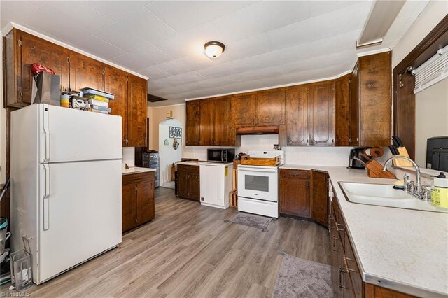 356 Davie Academy Rd, Mocksville, NC 27028 - kitchen with white appliances, a sink, light countertops, and light wood-style floors
