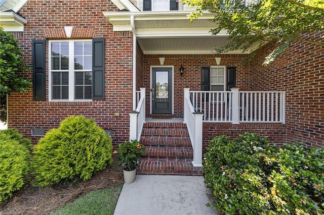 entrance to property featuring covered porch