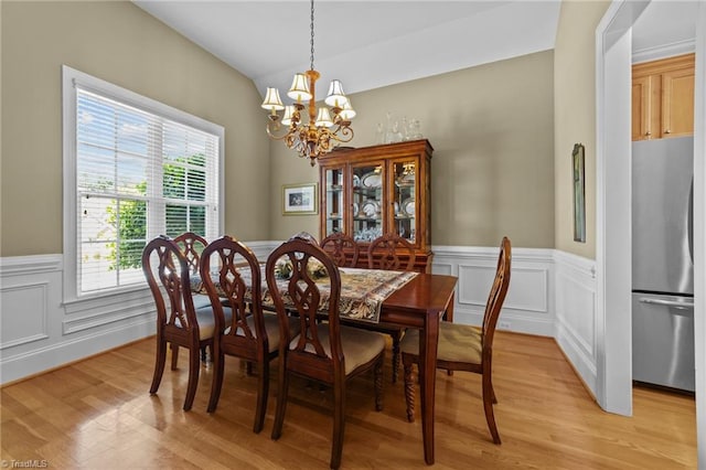 dining room with a chandelier and light hardwood / wood-style floors